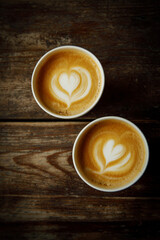 Love date concept. Two coffee cups with a heart latte art.