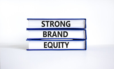 Strong brand equity symbol. Concept words Strong brand equity on books on a beautiful white table white background. Business, finacial and strong brand equity concept.