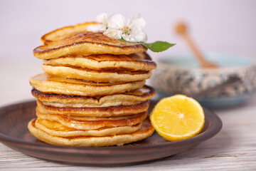 Fototapeta na wymiar Pancakes with honey, lemon