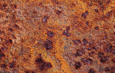 The rough texture of the rusty metal surface