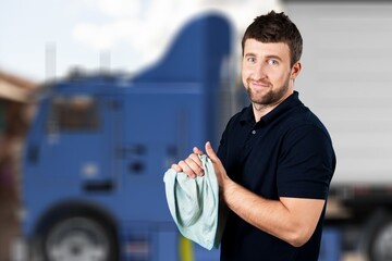 Portrait of confident truck driver on parking outdoor background