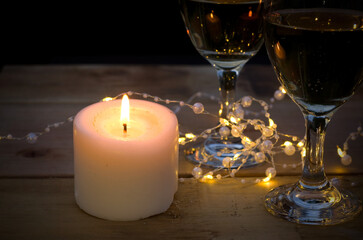 Candle Light with Wine Glasses on Wood Table