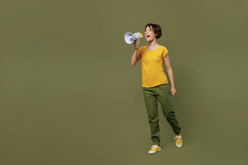 Full body young excited fun woman she 20s wear yellow t-shirt hold scream in megaphone announces...