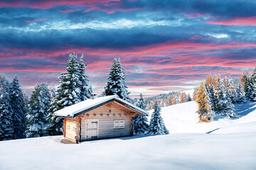 Picturesque landscape with small wooden log cabin on meadow Alpe di Siusi on sunrise time. Seiser...
