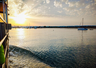 sunset over the Ria Formosa natural park in Algarve seen from inside the boat