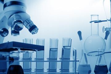 Microscope with lab glassware, science laboratory research concept