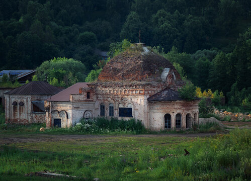 Abandoned old brick church in the countryside against the backdrop of the forest