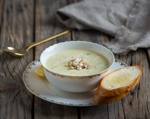chicken mushroom soup with garlic bread served in a bowl isolated on wooden background side view of soup