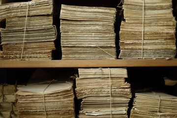 heaps and stacks of old papers and documents, storage of archives, long-term storage of notarial documents