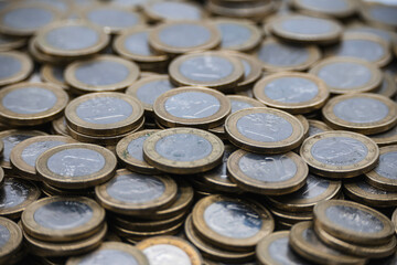 Euro coin, European currency pile.