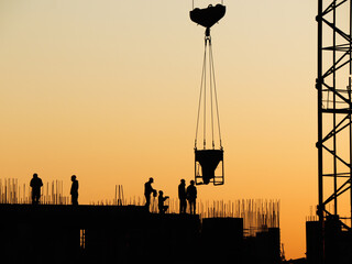 Builders build a house with a tower crane