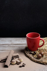 delicious chocolate snack, dark, white, next to a red mug, on a rustic wooden table. international...