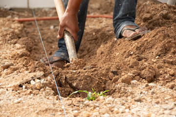 close-up shot of a man's hand digging with a shovel in the ground
