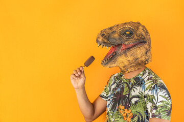 Male in dinosaur animal mask holding chocolate ice cream