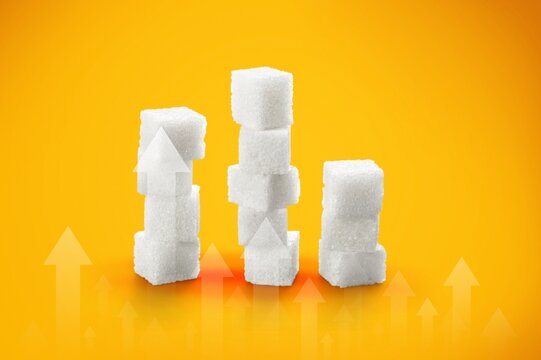 Ascending sugar cube graph with arrows indicating to reduce sugar intake and healthy nutrition.