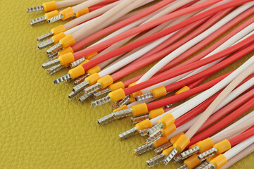 Copper electrical wires on natural colored leather close-up.