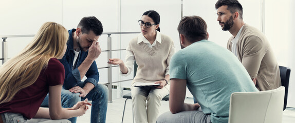 Psychotherapist working with group of drug addicted people at therapy session indoors. Banner design - obrazy, fototapety, plakaty