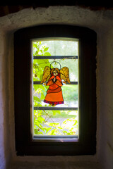 Image of the cute angel on the window of Radomysl Castle in Ukraine	
