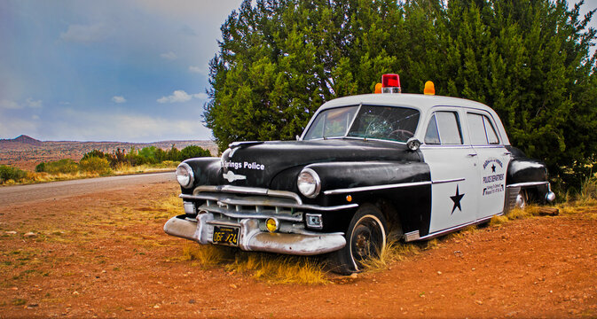 OLD, RUSTY POLICE CAR - ROUTE 66, ARIZONA, UNITED STATES. OLDSMOBILE.