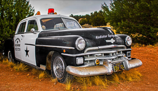 OLD, RUSTY POLICE CAR - ROUTE 66, ARIZONA, UNITED STATES. OLDSMOBILE.