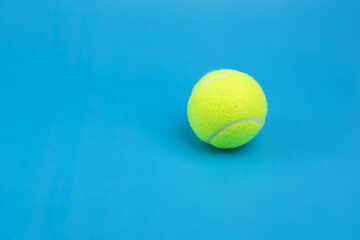 tennis ball on blue background copy space