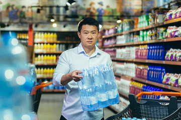 Portrait of an Asian man in crisis buying water in a supermarket.
