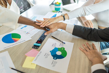 Diverse colleagues gather putting their hands together. Stack of hands. business people putting...