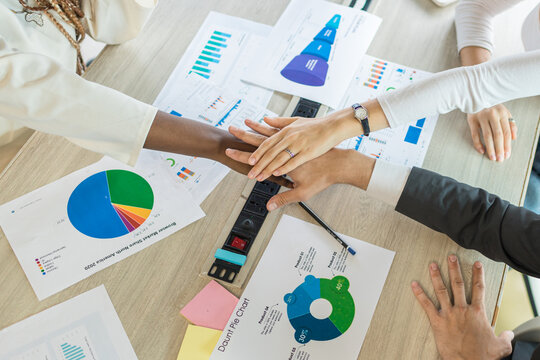Diverse colleagues gather putting their hands together. Stack of hands. business people putting their hands together