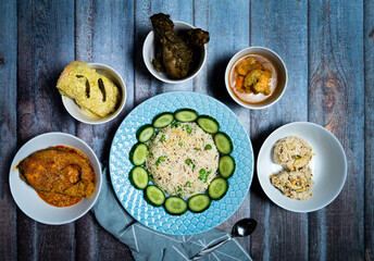 Assorted indian food decoration on the dark wooden background. Dishes and appetizers of indian cuisine.