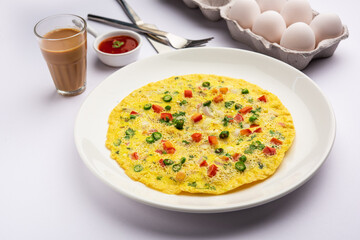 Indian Spiced Masala Omelet filled with fresh vegetable, healthy meal - obrazy, fototapety, plakaty