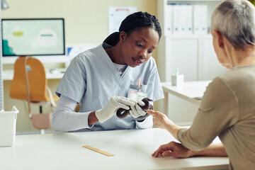 Portrait of young veterinarian examining snake at vet clinic, reptile specialist, copy space