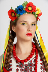 Beautiful Ukrainian girl in national costume vyshyvanka. Studio shoot on white background. Vse bude Ukraine