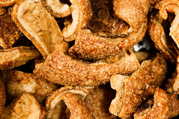 Close up of tasty pork cracklings or pork rinds. Crispy fried pig skin