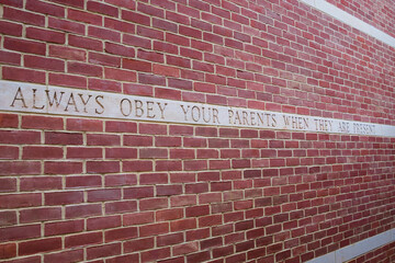 A quote on the wall, "Always obey your parents when they are present", in Mark  Twain house and Museum  in Hartford, Connecticut.