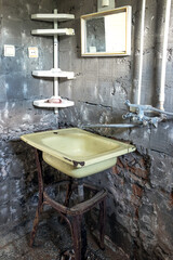 An old washbasin in a shabby place in a poor quarter. Kitchen under repair