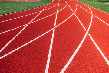 Sports stadium with red artificial rubber ground running tracks white lines on it