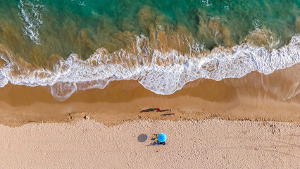 aerial drone view family at the beach