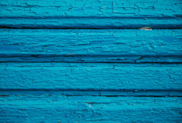 Wooden boards painted in blue. Rough and cracked surface. Old wood and paint.Background and texture.