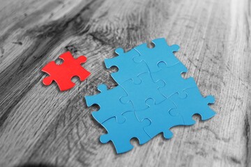 completing whole puzzle with last piece. Jigsaw  with missing pieces in the center.