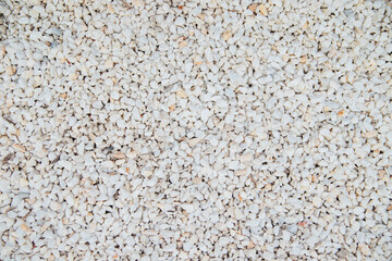 The background is made of stones of different sizes and colors. The texture of natural stones.