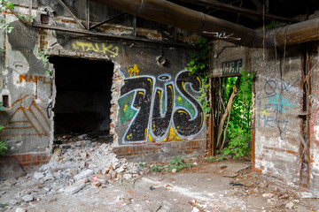 Inside in a ruined railway station building with graffiti
