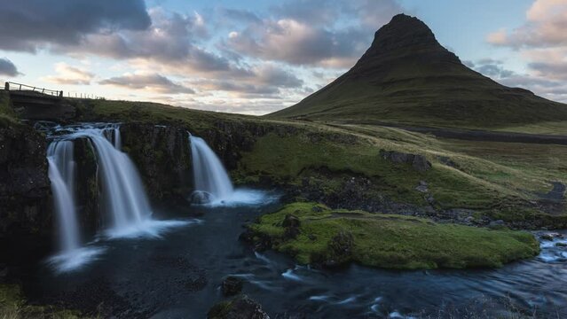 A time lapse of the most famous photo spot
in Iceland. The Kirkjufellsfoss with the Kirkjufell mountain in the background at sunset with colored clouds.