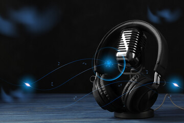 Retro microphone and headphones with illustration musical notes on table against dark background....