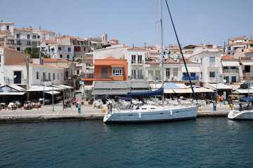 Fototapeta na wymiar Beautiful view of coastal city with sailboat on sunny day