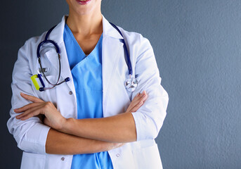 Portrait of young woman doctor with white coat standing in hospital. - 517788565