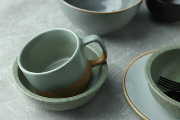 Obraz na płótnie Canvas Stylish empty dishware and cup on light grey table, closeup