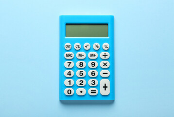 Light blue calculator on turquoise background, top view