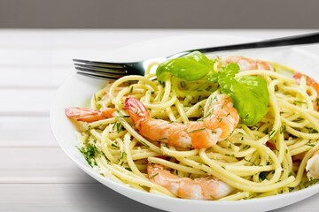 Classic Italian Pasta Spaghetti on plate with wooden table background. Simple and easy vegetarian dish.