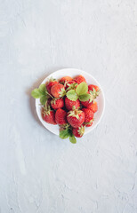 Strawberry fresh organic fruit in a plate. A bowl with fresh juicy strawberries. Homegrown strawberries.