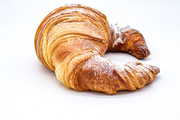 croissant with powdered sugar on white background